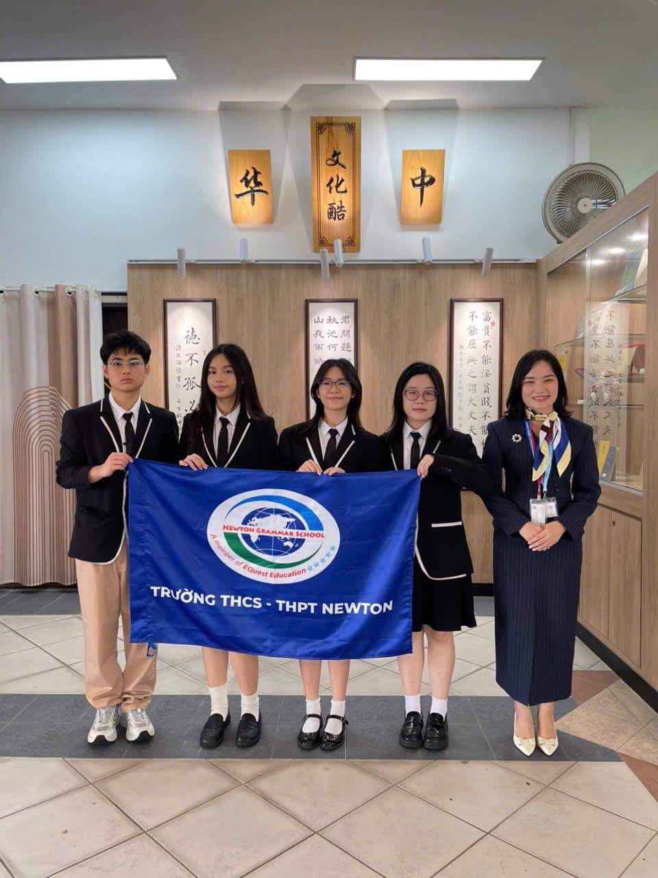 Newton delegation with the school flag at Hwa Chong, Singapore